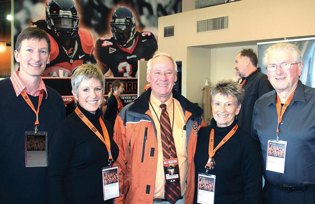 Chuck and Kay Merrill with Ed Ray taking group photo at University Day