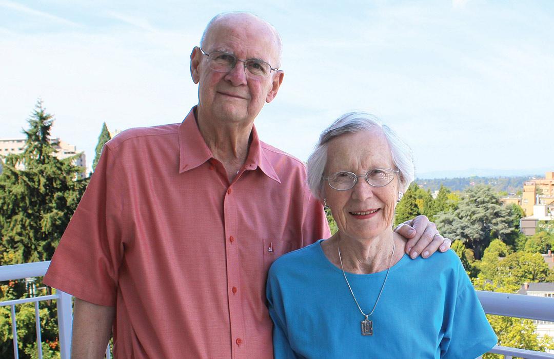 Ben and Elaine Whiteley standing on balcony overlooking town