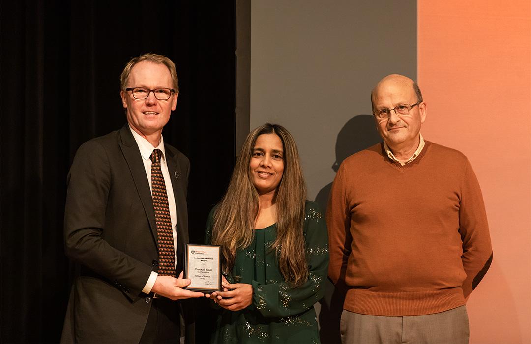 Vrushali Bokil receiving award from colleagues on stage