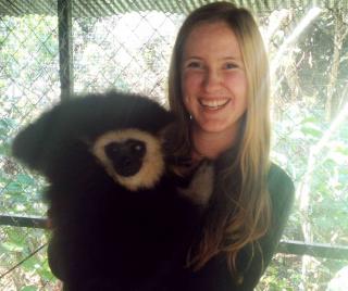 Karianna Crowder holding a lemur at a zoo.