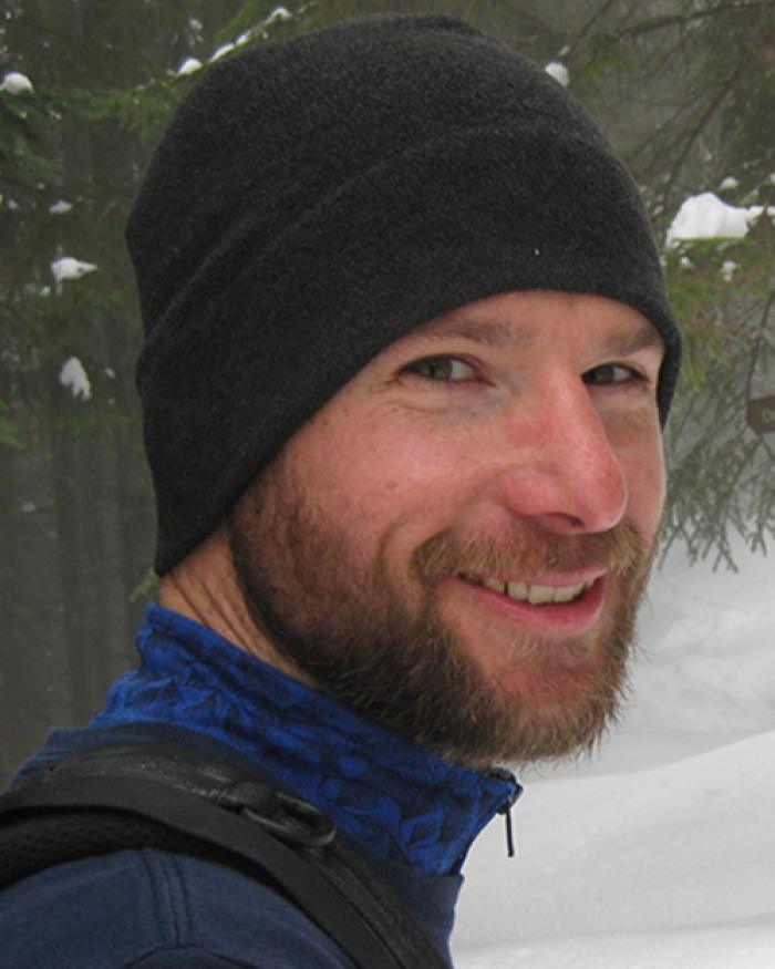 Mark Novak standing in snowy forest